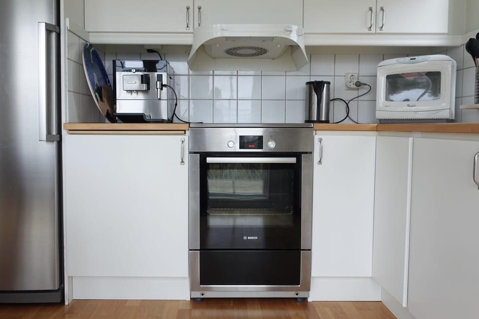 Oven, microwave, and coffee machine are available.