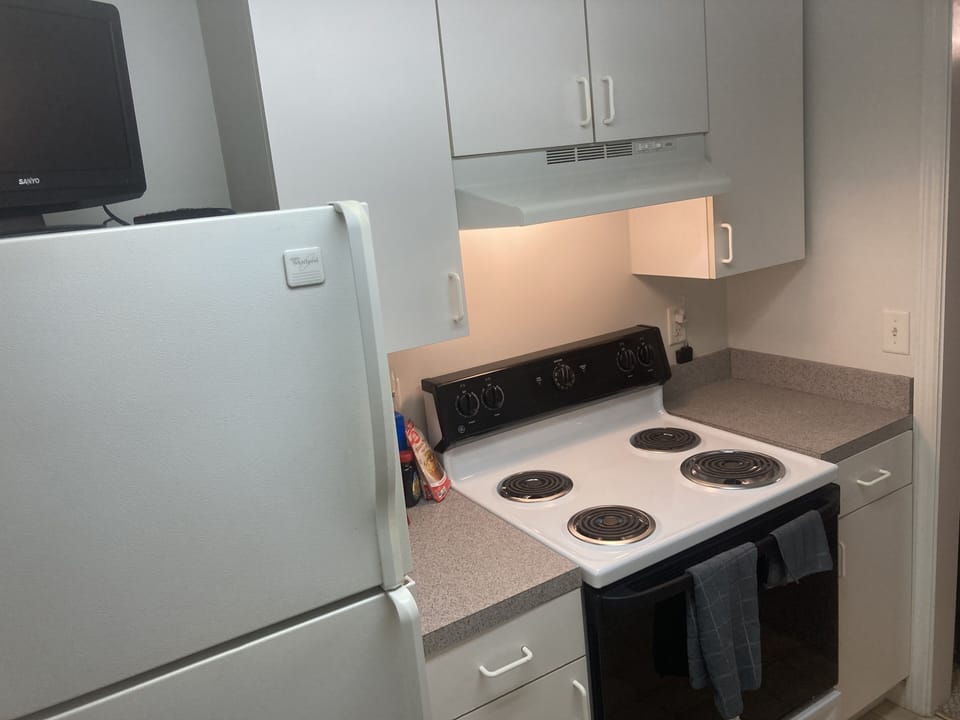 Kitchen. TV, stove. Dishwasher, sink, coffee maker and microwave are behind me.