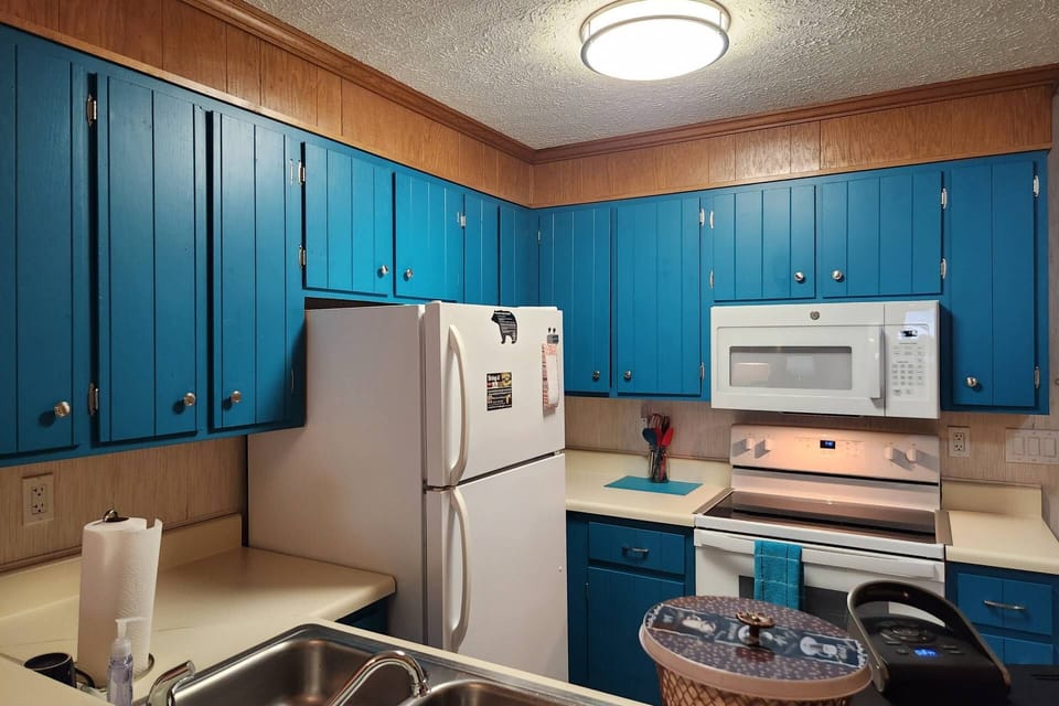 The bright and cheery kitchen offers all the essentials to cook meals