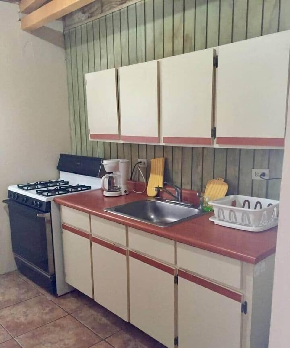 A equipped kitchen with a sitting breakfast area.