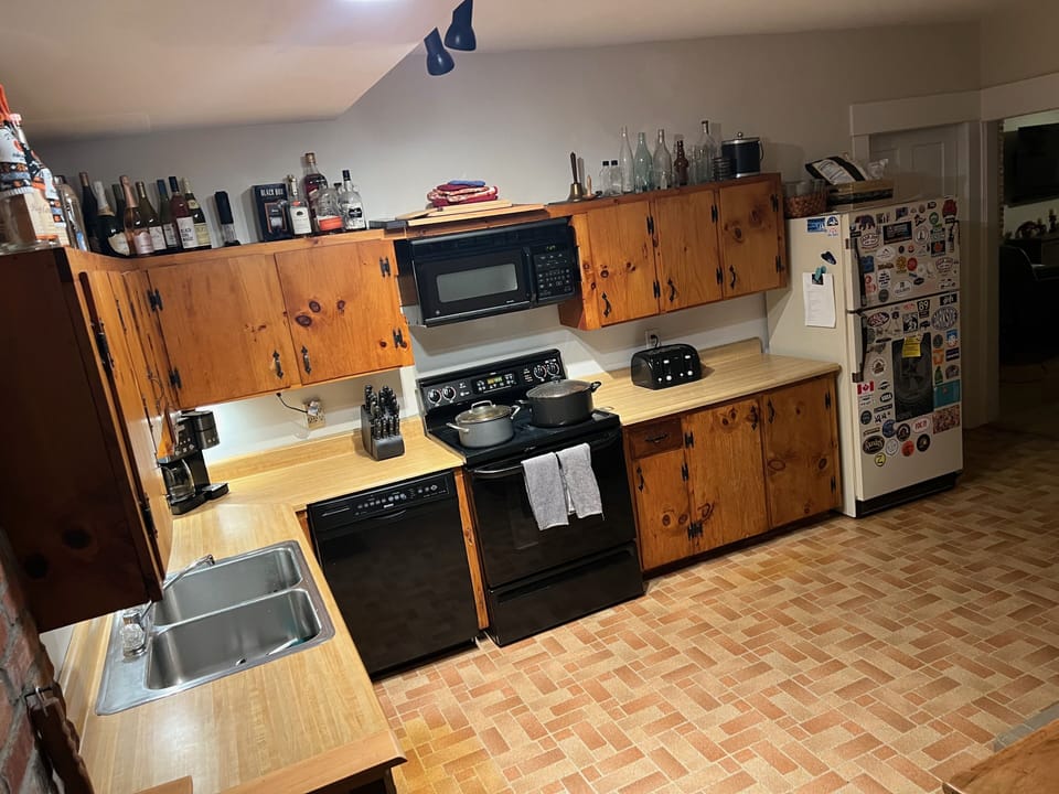 Full kitchen with dishwasher, coffee maker, cookware and spices