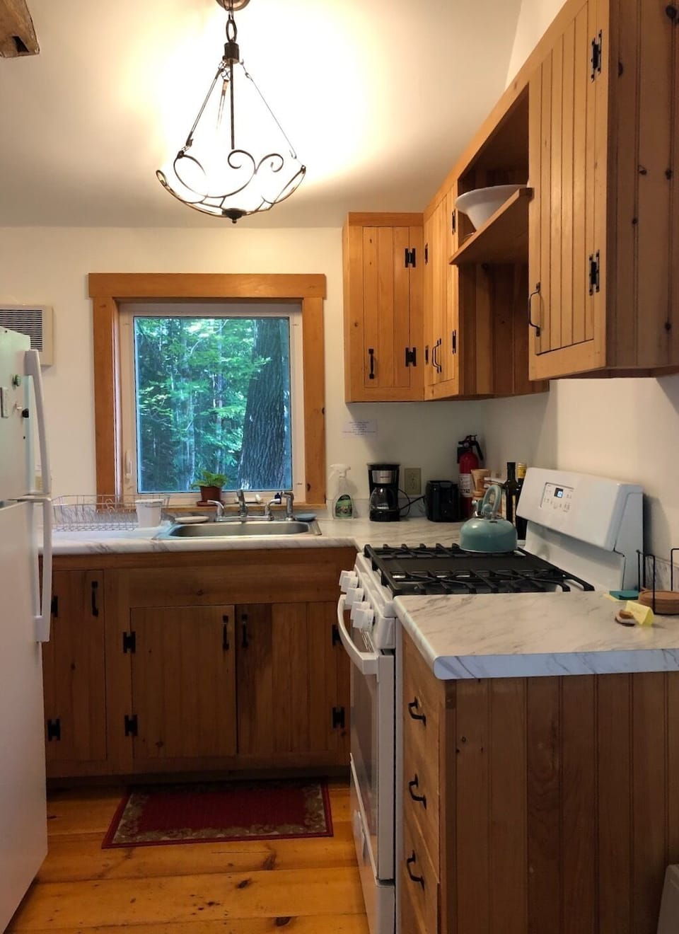 The galley kitchen is kept stocked with cooking supplies, coffee and tea.