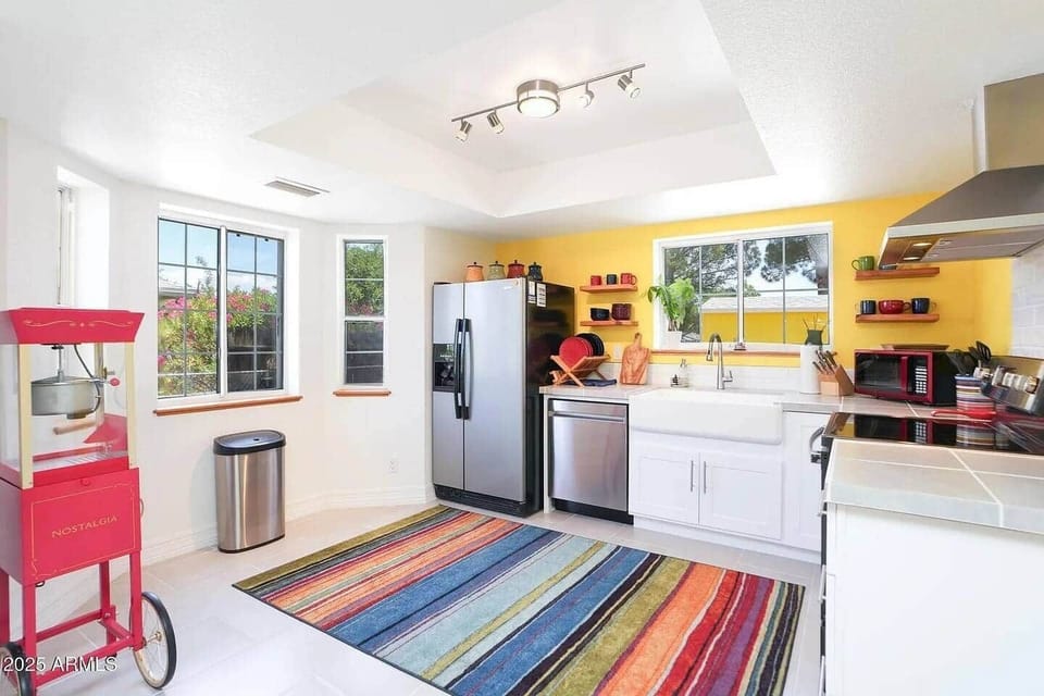 Well-lit kitchen with windows and open space—ideal for relaxing mornings and home-cooked meals