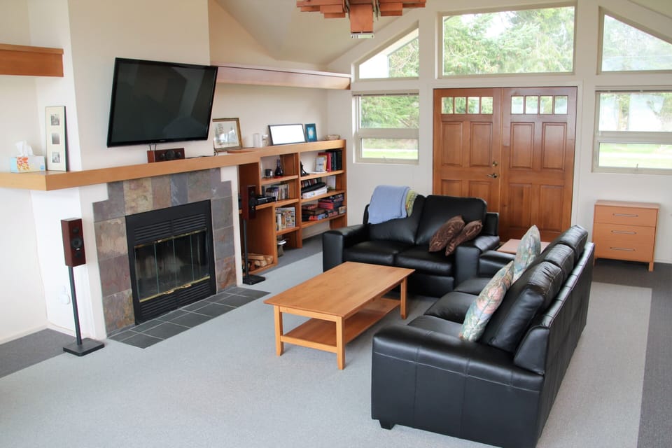 Inviting leather couches, a wood burning fireplace & a 55” flat screen TV.