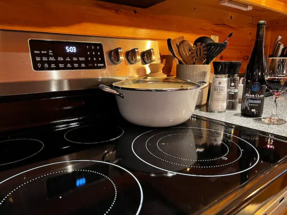 The kitchen has cooking supplies and an electric range/convection oven.