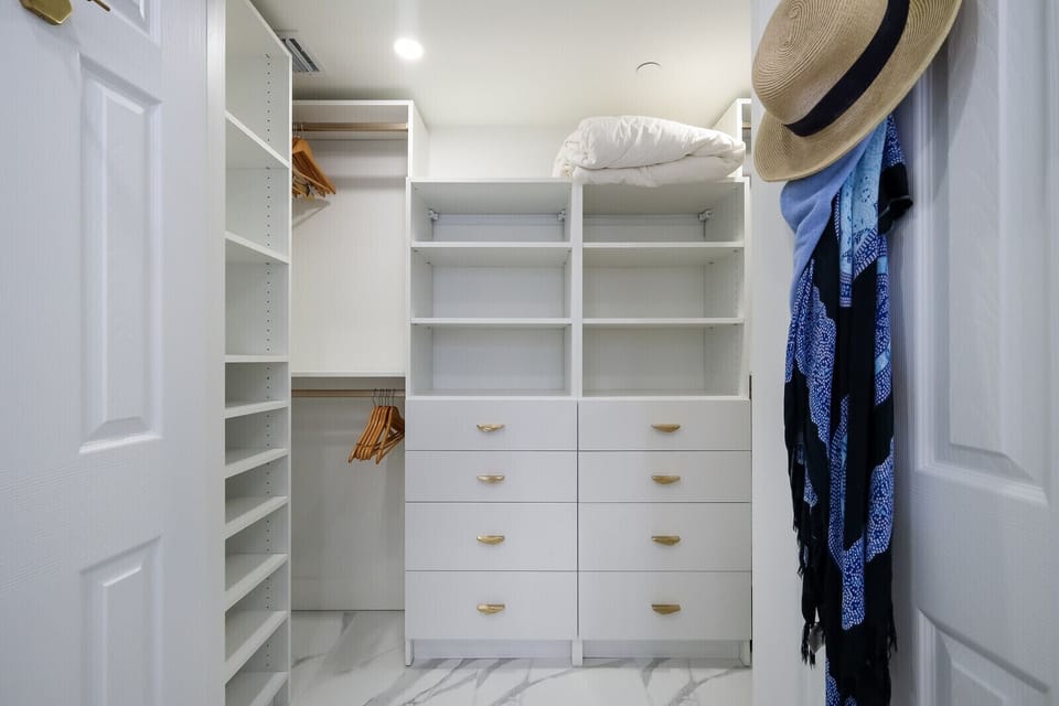 Primary walk-in closet with ample storage