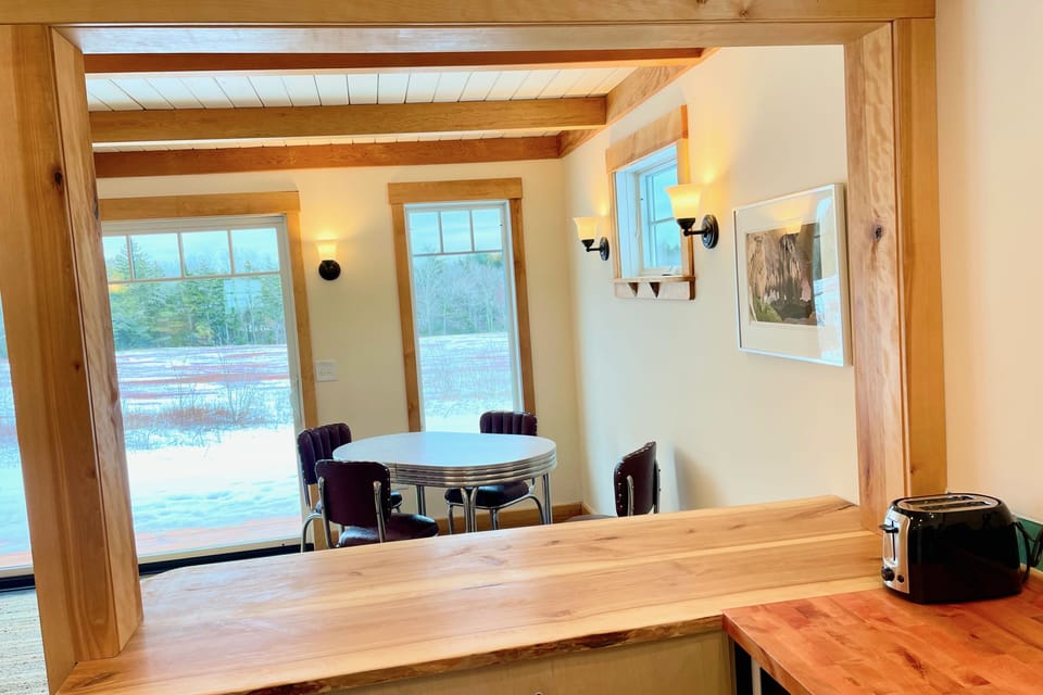 Handmade yellow birch breakfast bar with stools and pass-thru to dining room