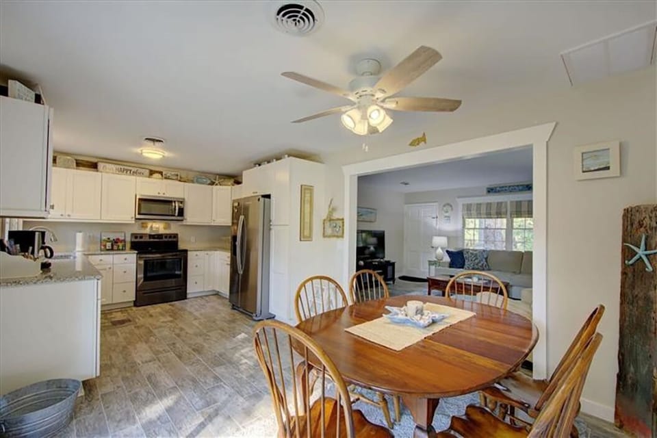 The dining table has two additional leaves allowing it to expand.