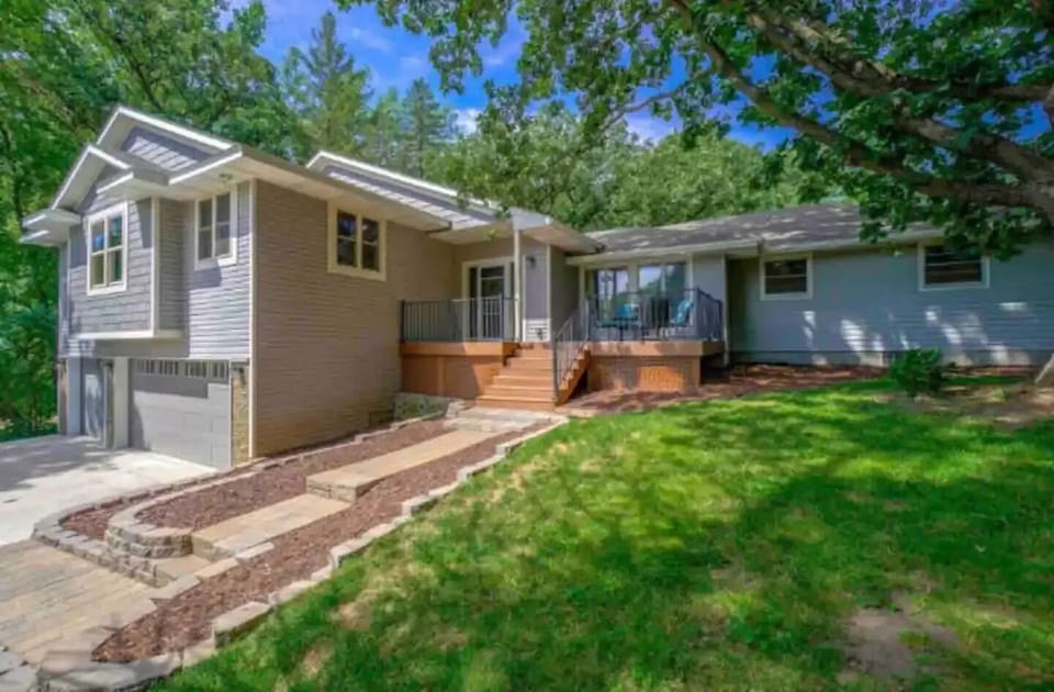 Front entry of home in spring. 3 car garage.
