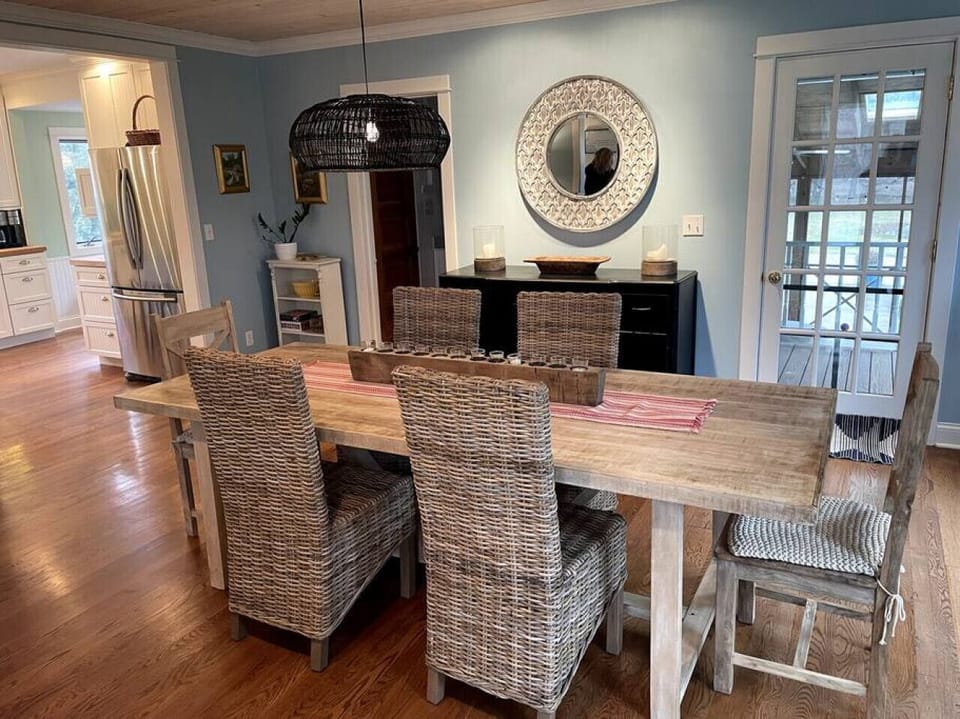 Dining room leading to kitchen, family room screened in porch