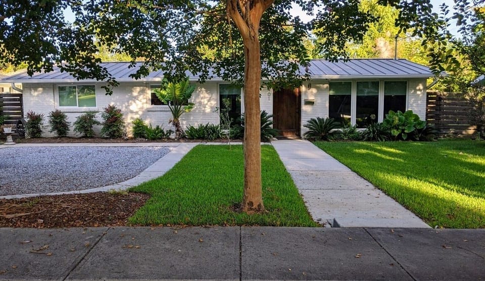 Front view of home that has a wonderful setting for rest and entertaining.