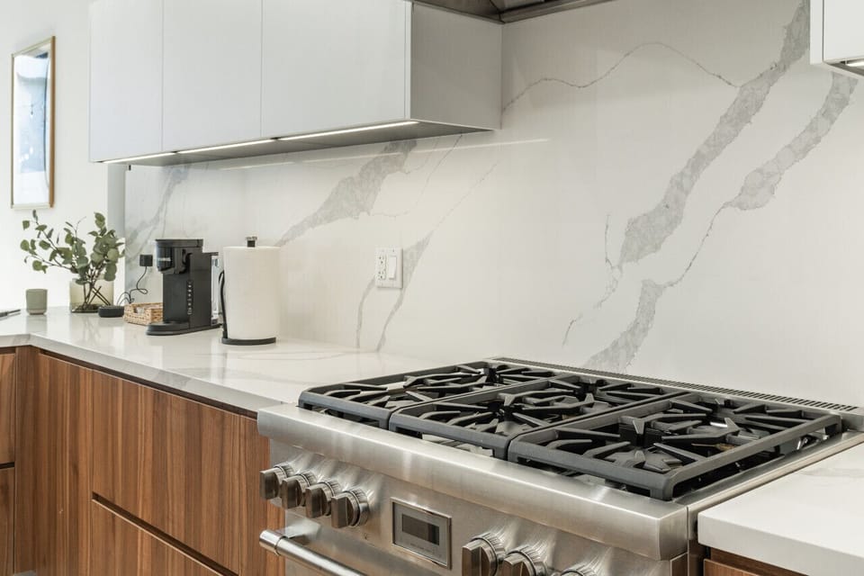Modern gas stove with marble backsplash