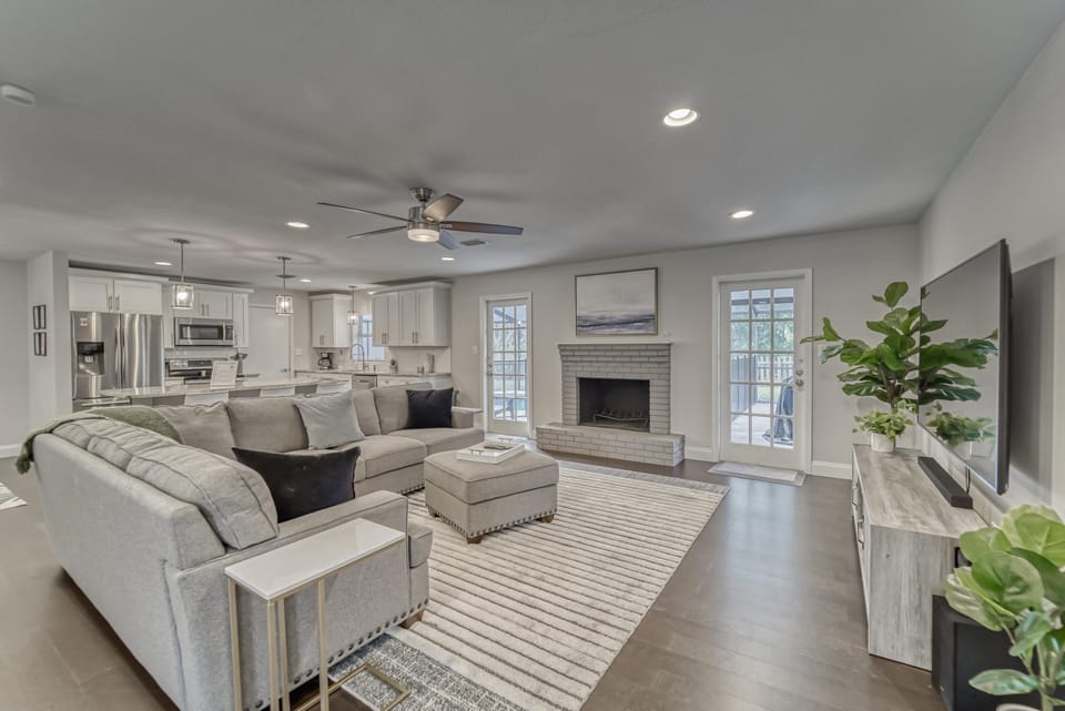 Living room with large Smart TV, fireplace and air hockey table.