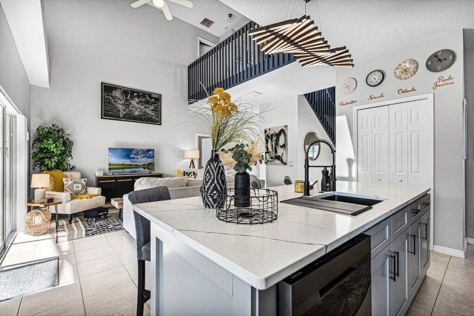 Fully loaded kitchen with island, comfortable bar seating, overlooking main living area, pool and deck.