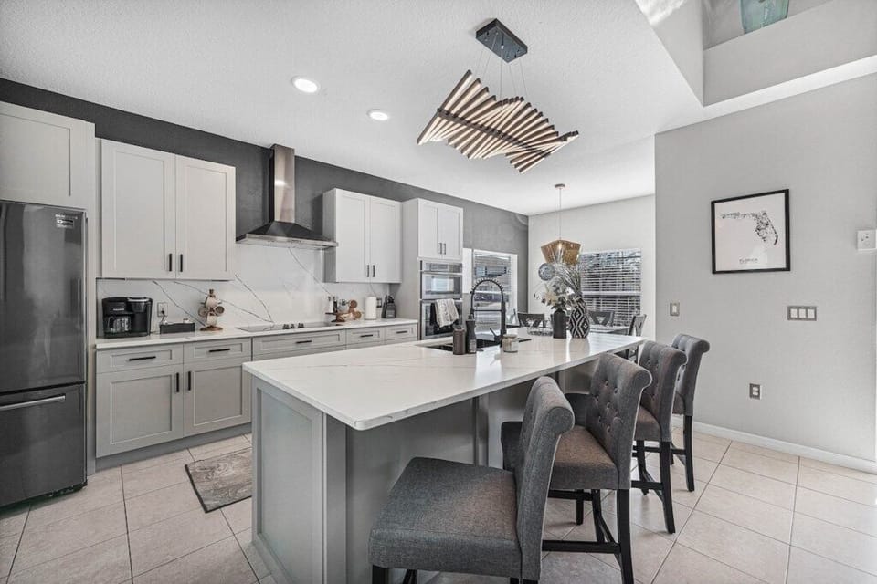 Spacious kitchen with large island, bar seating, double oven, microwave, keurig coffee machine, large fridge freezer.