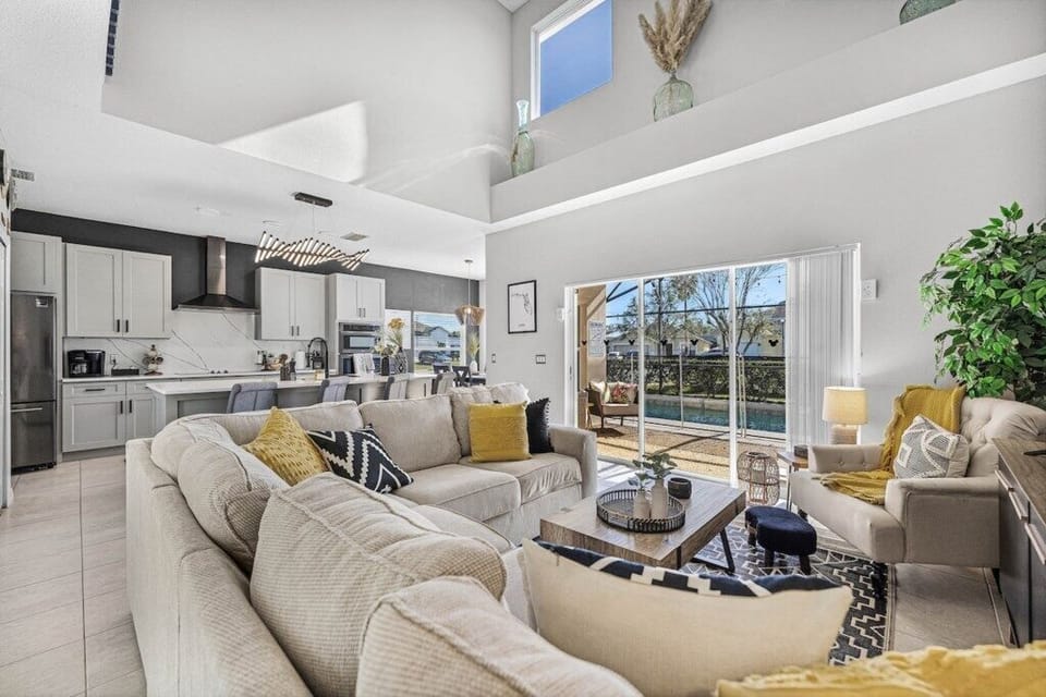 Spacious living room overlooking pool and pool deck, great for watching movies!