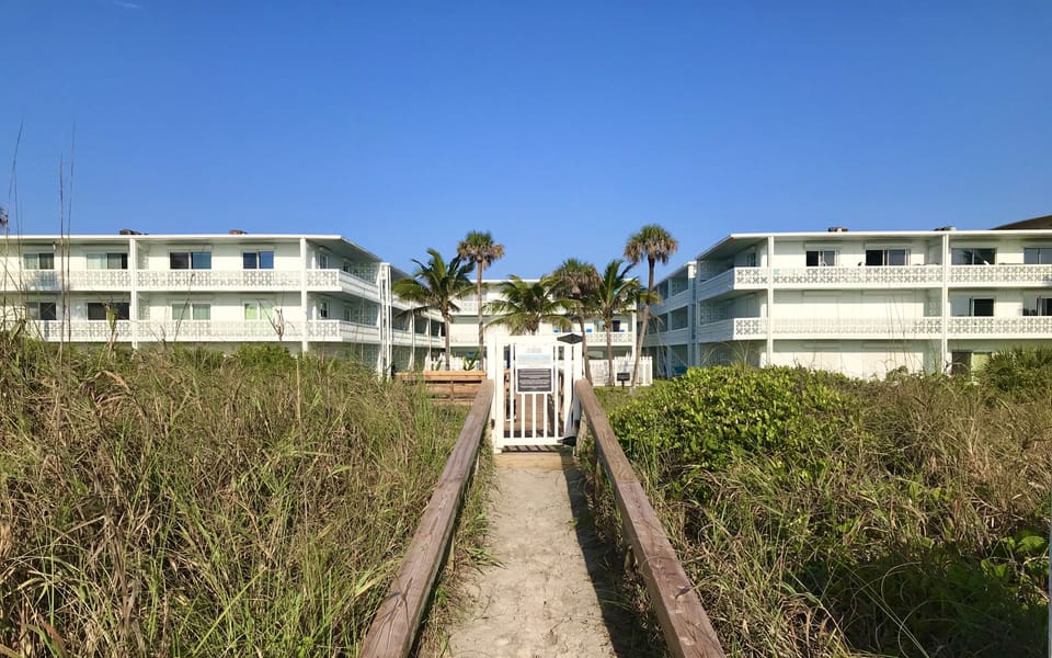Private boardwalk from back of building to the beach.