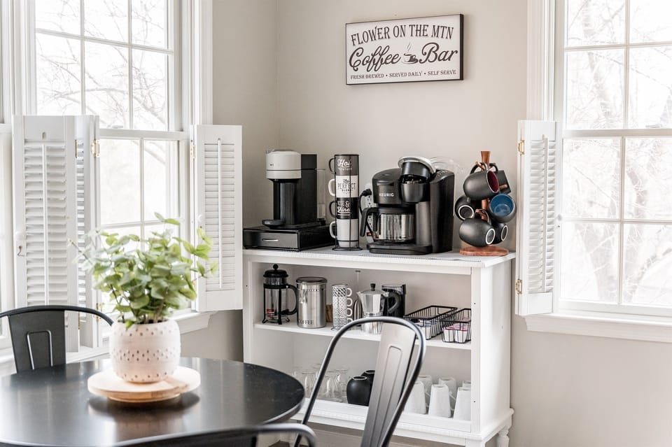 The coffee bar is an inviting space that offers more than just a caffeine fix. With its state-of-the-art equipment, including a Keurig Duo, Nespresso machine, French press, stove-top espresso maker, and fresh bean grinder, you'll be able to brew all day!