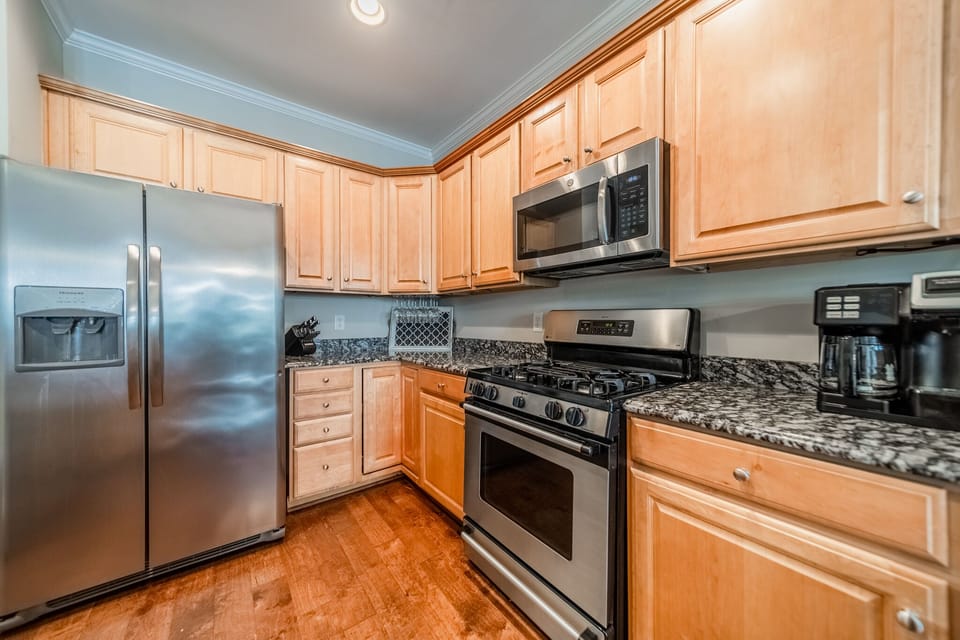 Fully stocked kitchen with island & granite countertops.