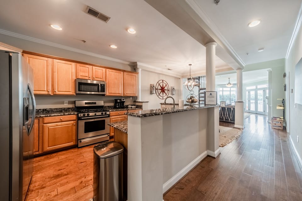 Fully stocked kitchen with island & granite countertops.