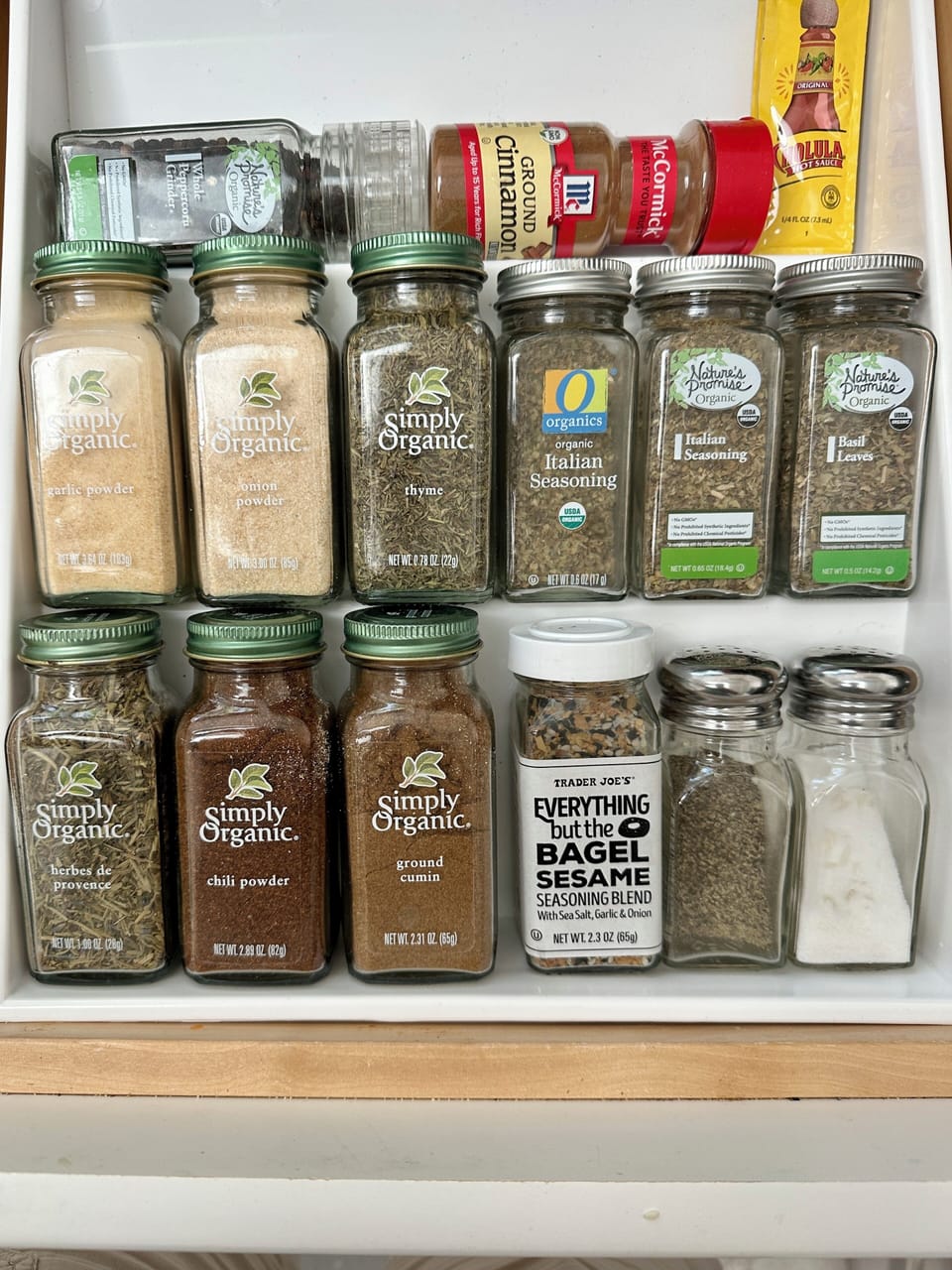 Spice rack is in the drawer, next to the sink.