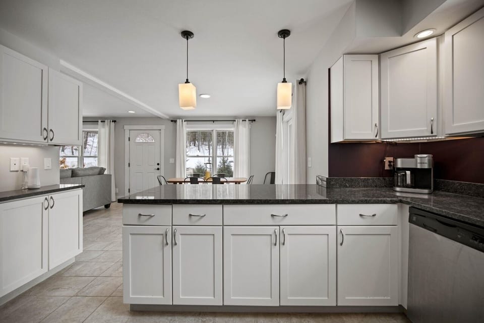 East side of the kitchen has serving tools utensils, dinnerware & coffee station