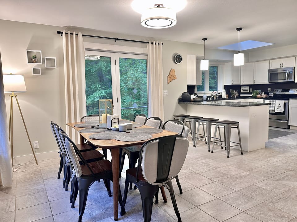 Dining room and kitchen in the back as seen from the living room area. 