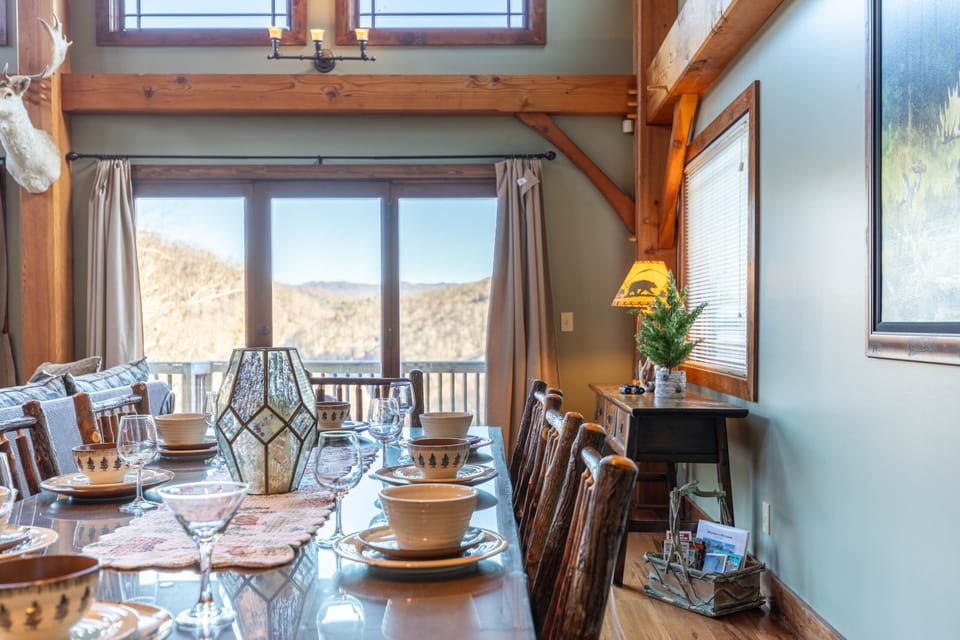 Gather around the table with mountain ridges filling every window. Rustic log chairs and warm timber beams set the tone for every meal.