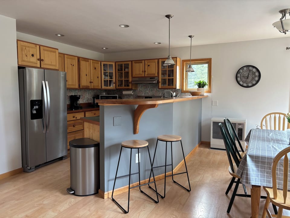 Kitchen with full size refrigerator and freezer.