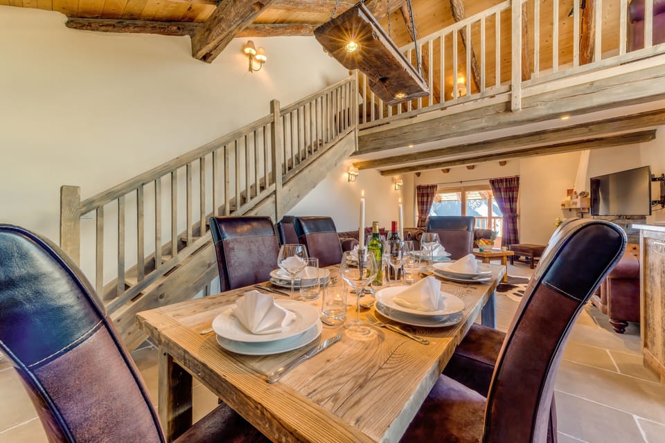Large dining table comfortably seats 8. The light is a repurposed cattle yoke.
