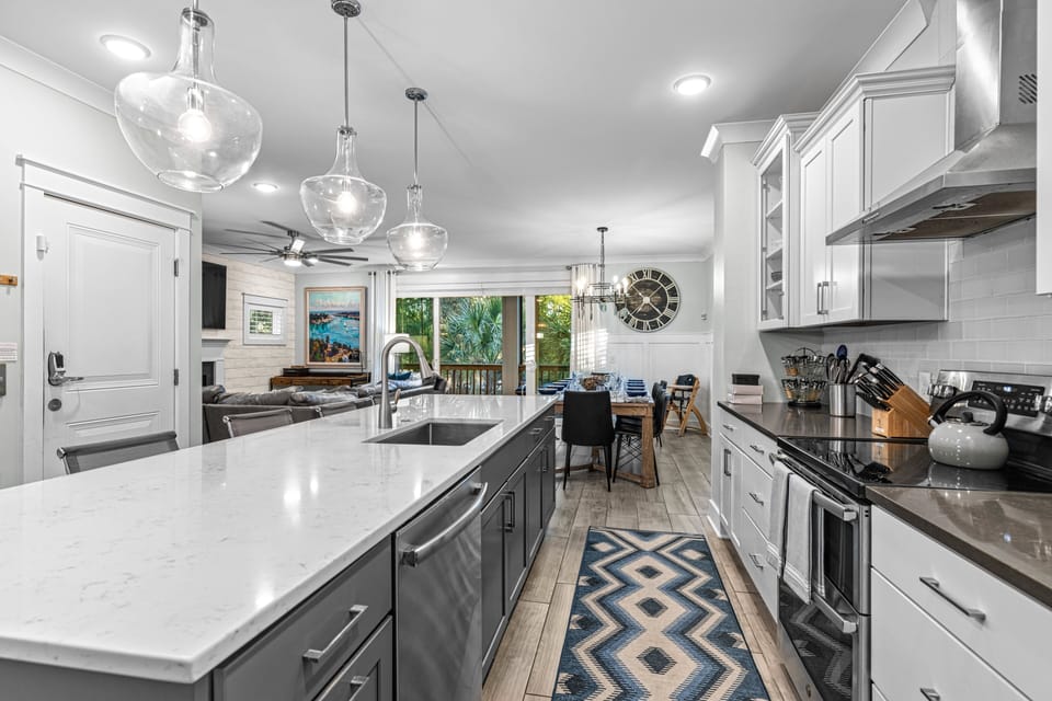 Gourmet kitchen features high end cabinets with Quartz countertops. Island seats 5.