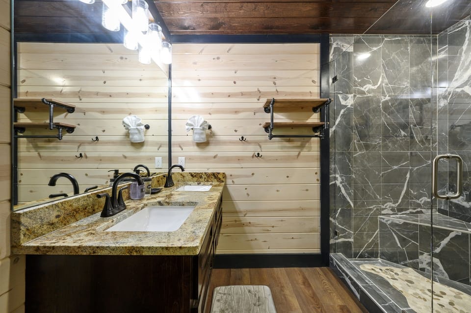Private bathroom with double sinks and walkin shower.