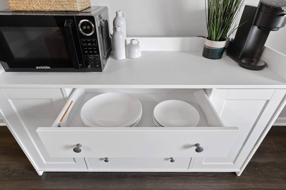 Beautiful ceramic plates, cups, and bowls are located inside the drawer, ready for those lovely breakfast, lunch, or dinner!