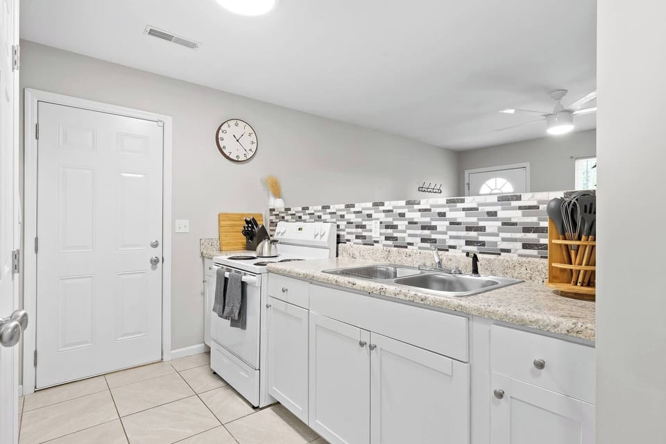 Take a look of our kitchen area, ready to be used for some home cooked meals! Our pots and pans can be found in the kitchen cabinets and there are some baking sheets in the storage drawer under the oven.