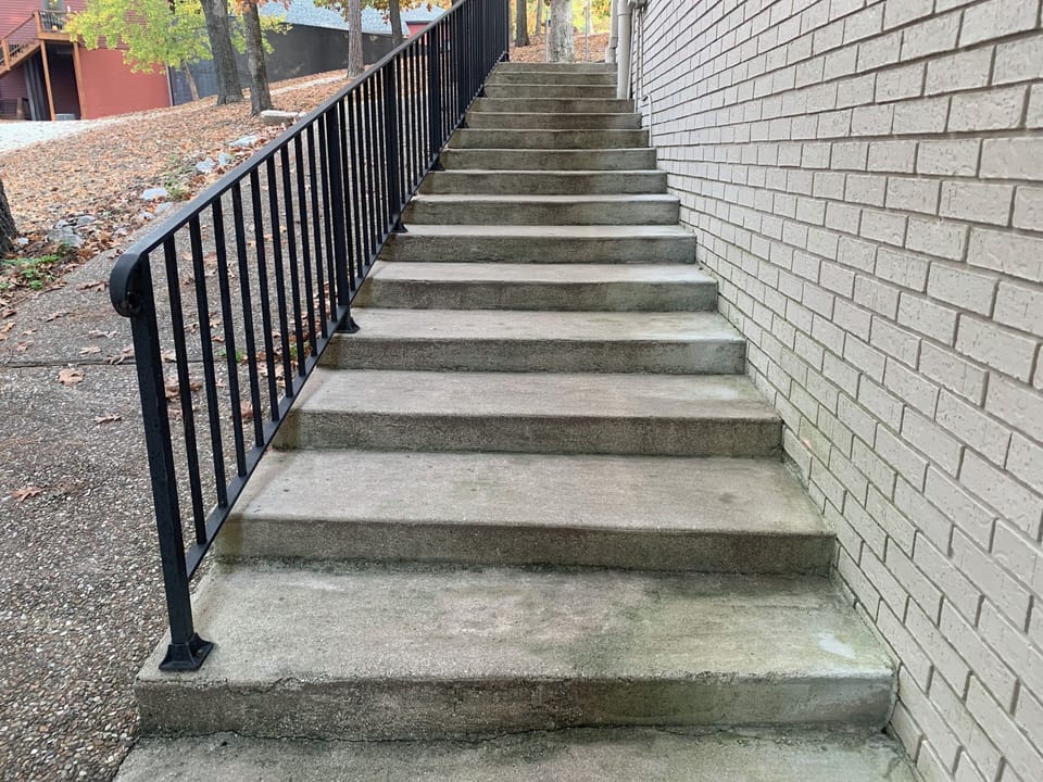 You will need to  go down these stairs or the sloped walkway to enter.