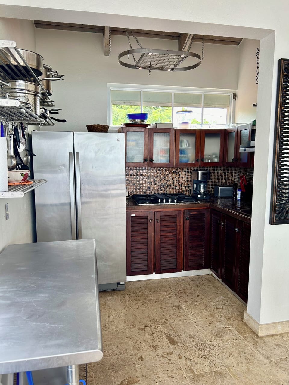 Kitchen with stovetop, toaster oven, refrigerator, blender, and coffee maker 