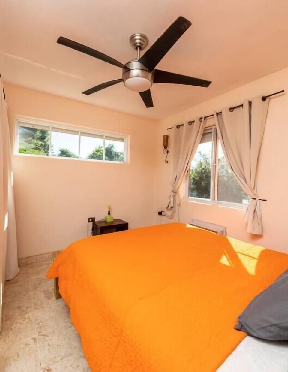 Main level bedroom with Queen bed and garden view