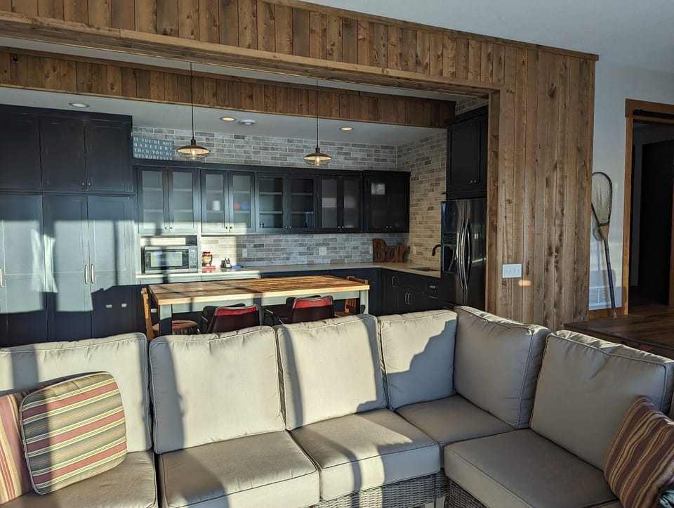 Lower Level Kitchen and Sitting Area with TV. Walkout to Patio.