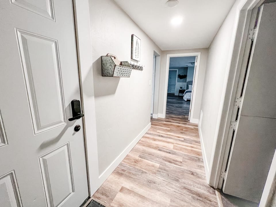 View from hallway as you enter the house from garage service door. Mudroom/bedroom w/ twin bed to the right with kitchen, LR, and bedrooms straight ahead :)