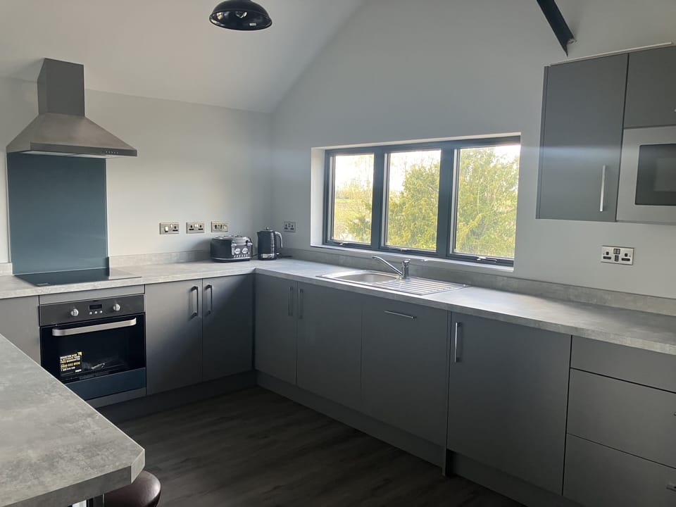 Large kitchen with oven, dishwasher, microwave, fridge  