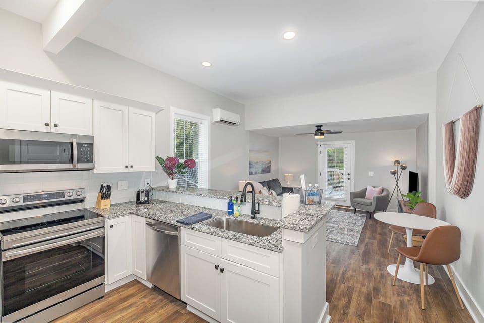 Light-filled, open-concept living room, kitchen and dining areas.