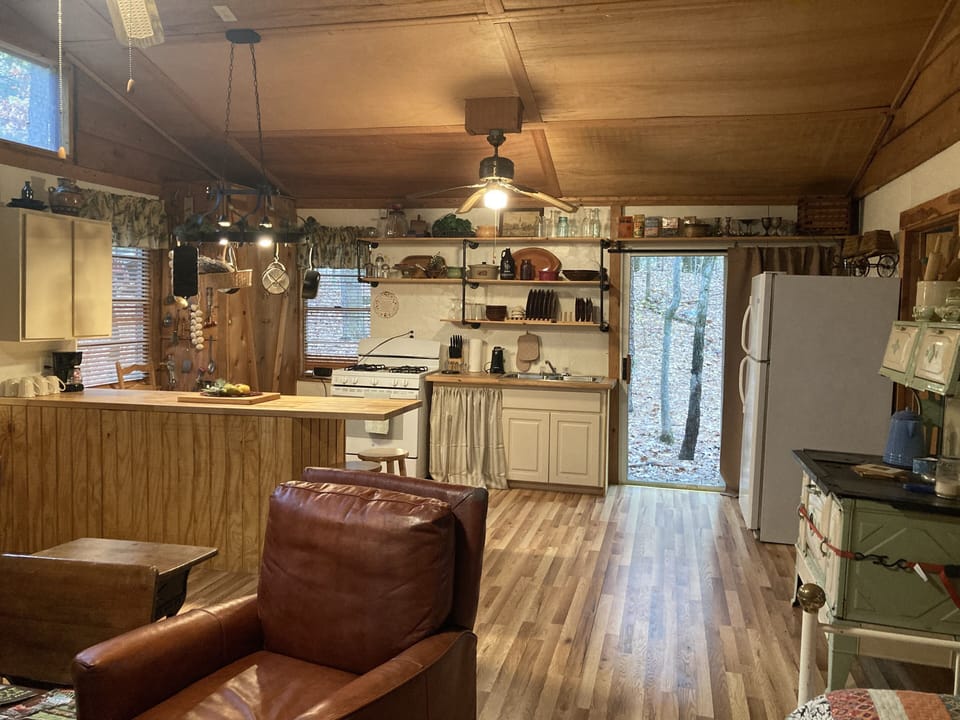 Kitchen equipped with dishes, pots & pans. Coffee pot, salt/pepper.
