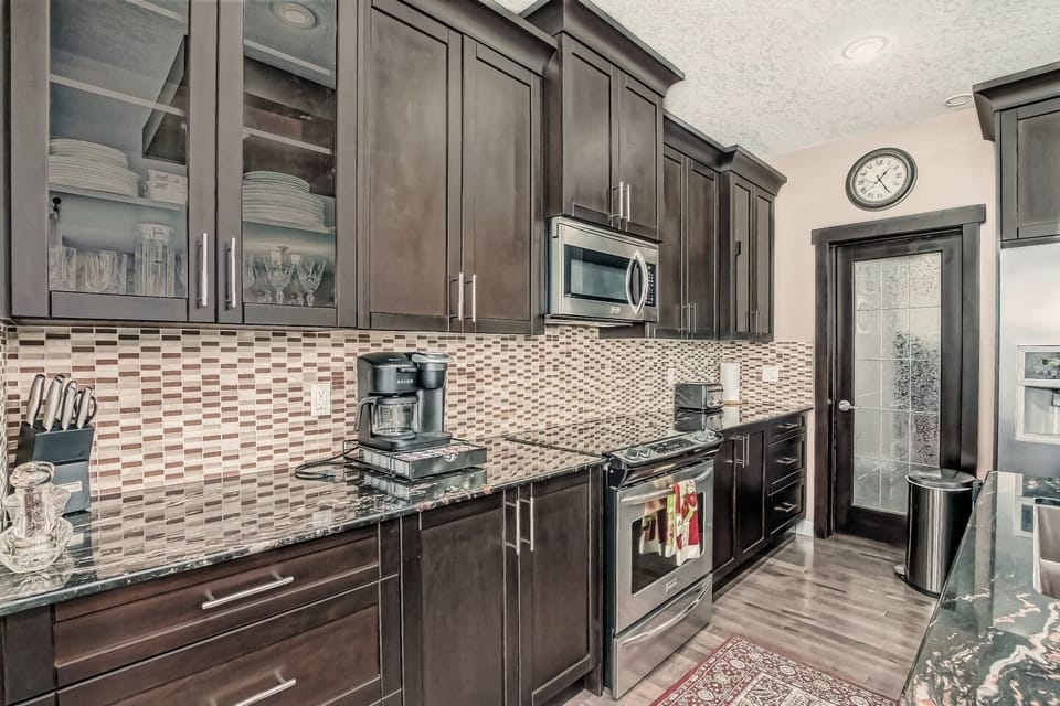 Beautiful and functional modern kitchen with all the utensils, pans, pots & cups