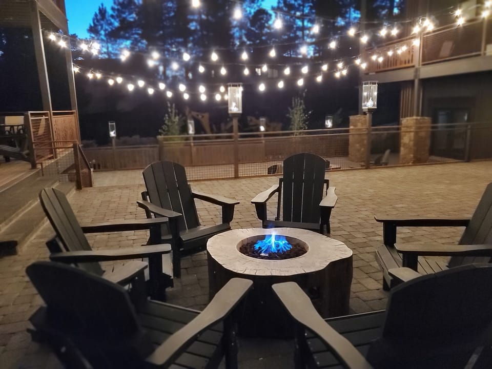 Enjoy evening conversation by the fire with gas lanterns and twinkle lights above