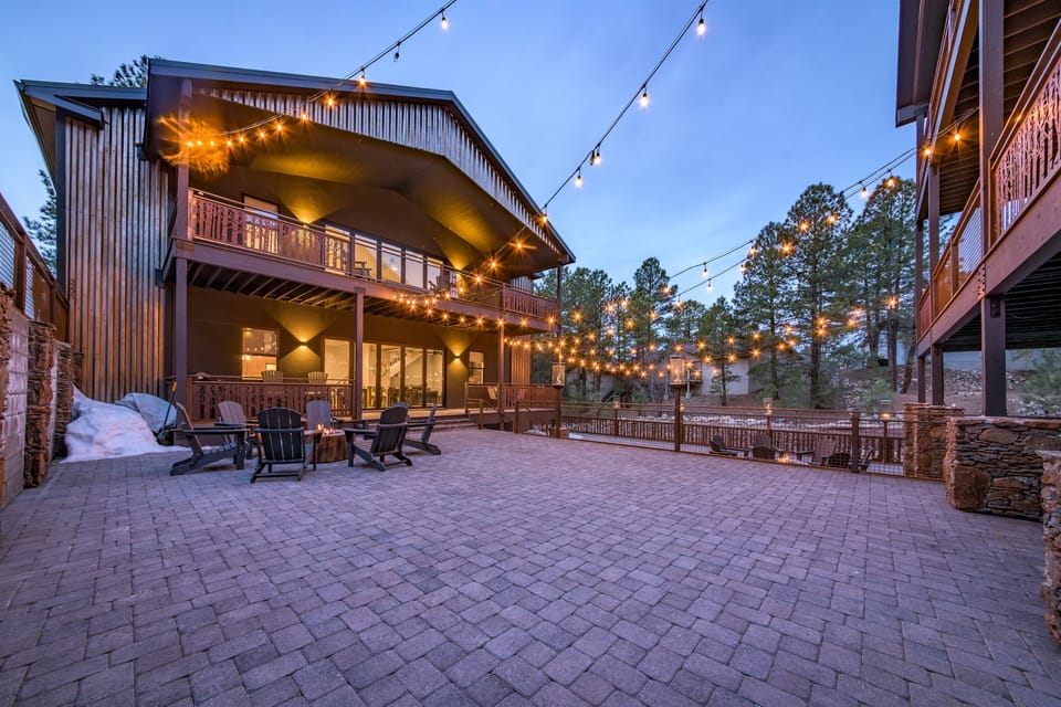 Your patio space lit up by twinkle lights and propane fire pit