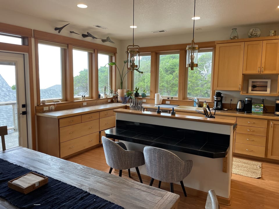 Bar top that seats 2 people, next to dining table 