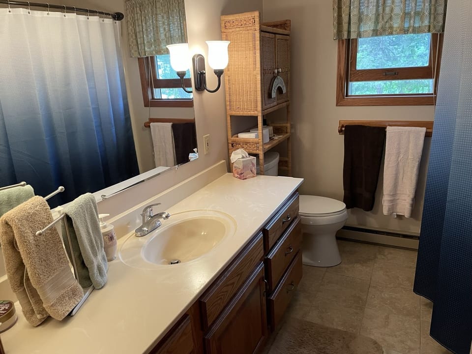 Upstairs bathroom with tub and shower.