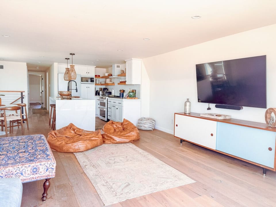 Quality furnishings including a comfy couch, bean bags, and chic accessories.