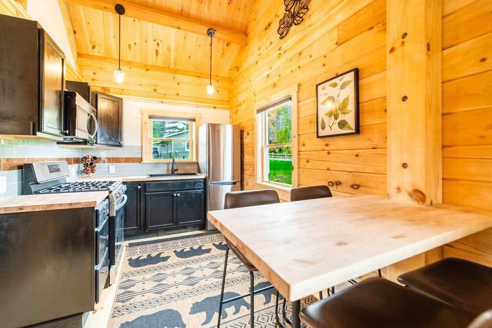 It's not fancy but very practical.  The small dining table is a bar top with 4 bar stools/chairs right next to the kitchen.  A perfect place to enjoy a home cooked dinner or breakfast.