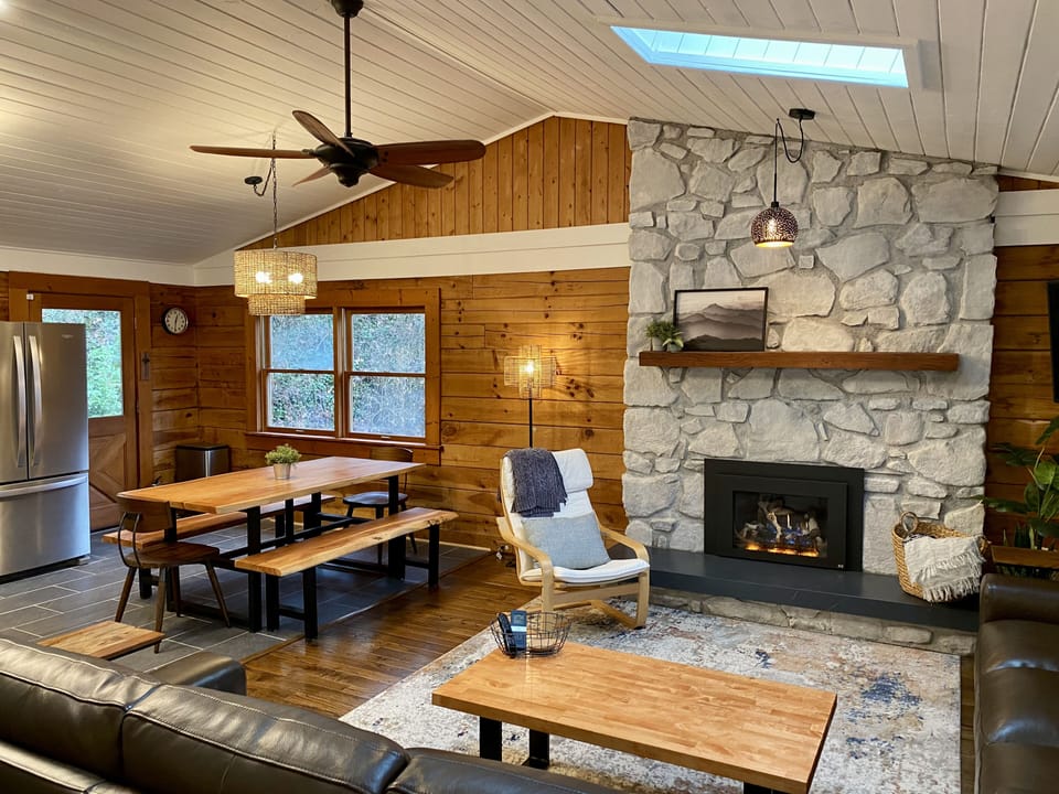 Spacious main living area with stone hearth and gas fireplace